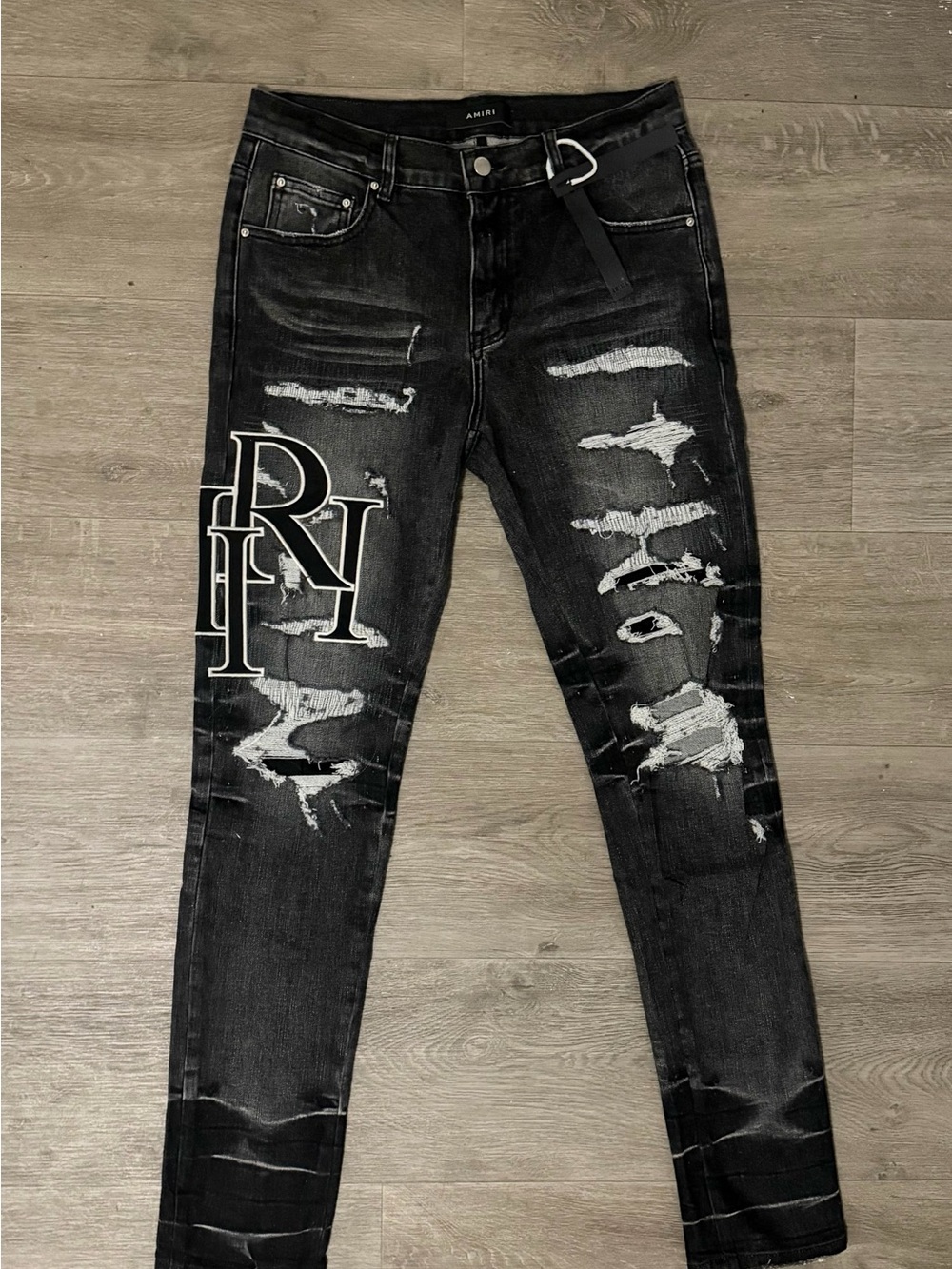 AMIRI Black Distressed Skinny Jeans with White Logo